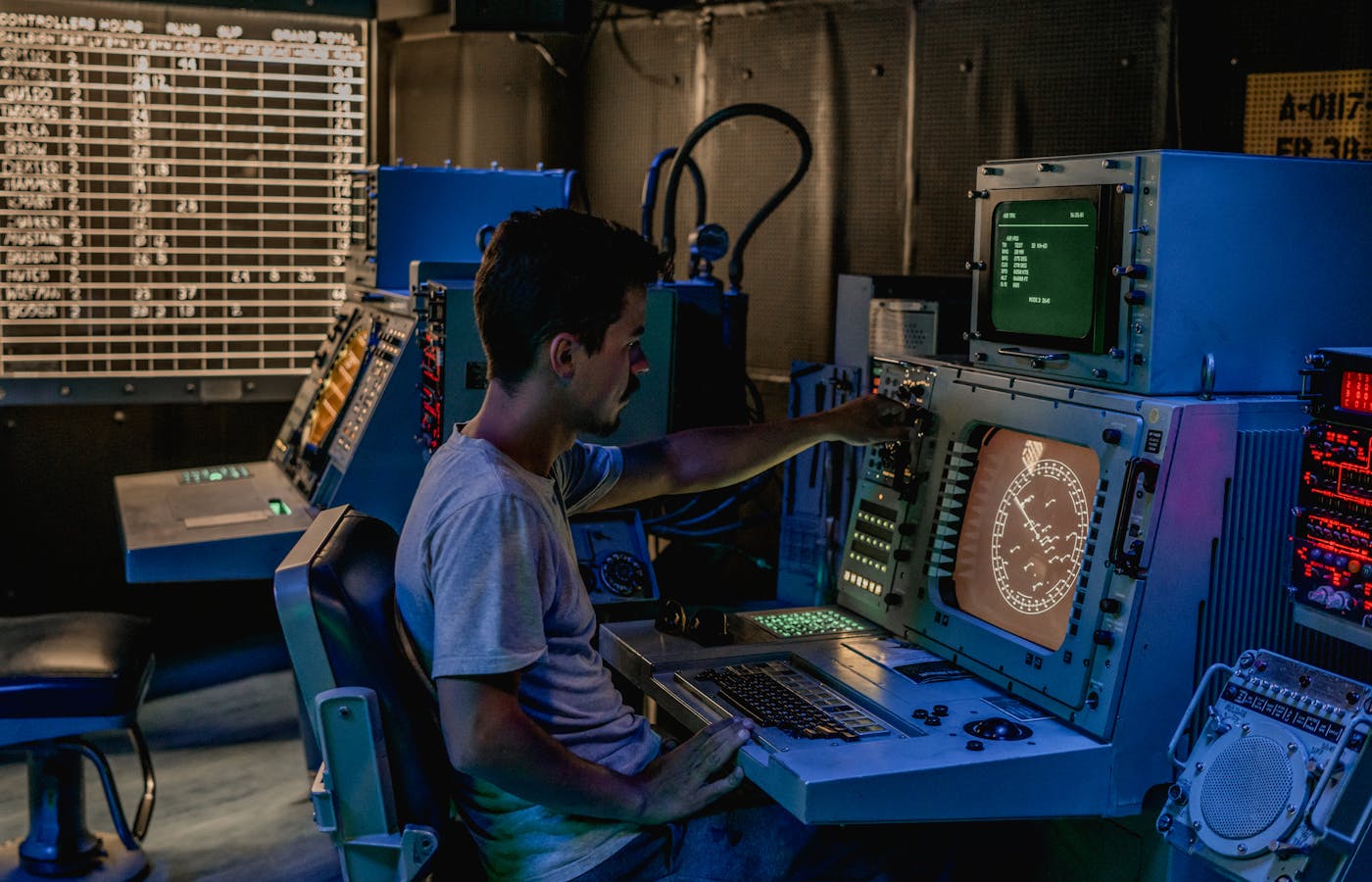 Operator monitoring radar screens in a command center